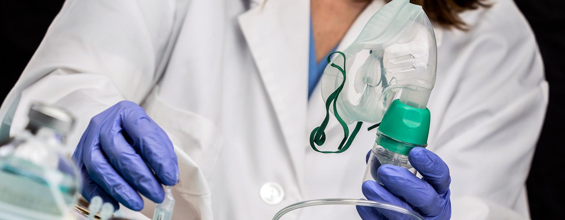 Respiratory therapist holding oxygen mask